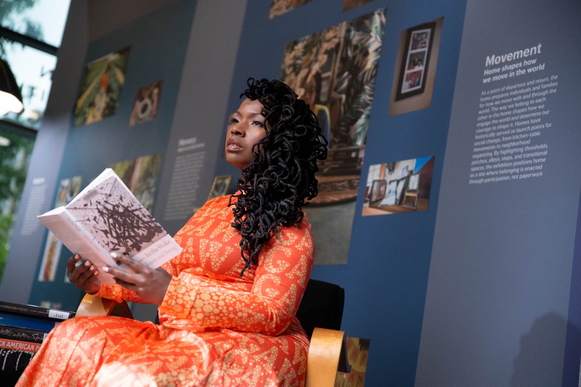 A reading chair in the exhibition beside the Movement wall panel